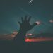 person hand and crescent moon